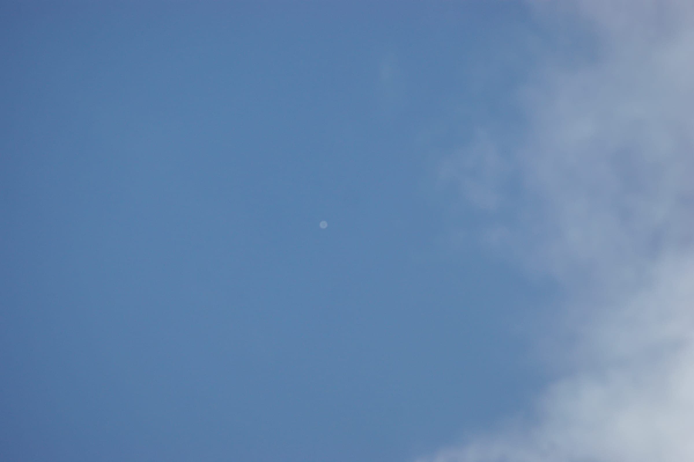 A high-altitude balloon and its payload photographed high above the clouds